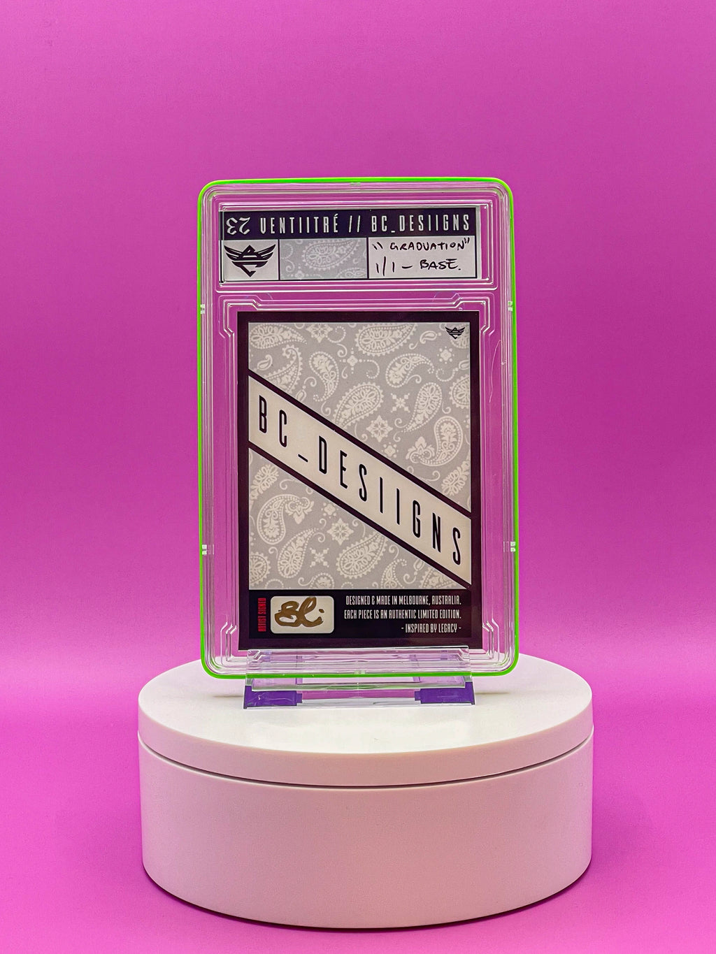 Trading card in a protective case on a pink stand with a pink background