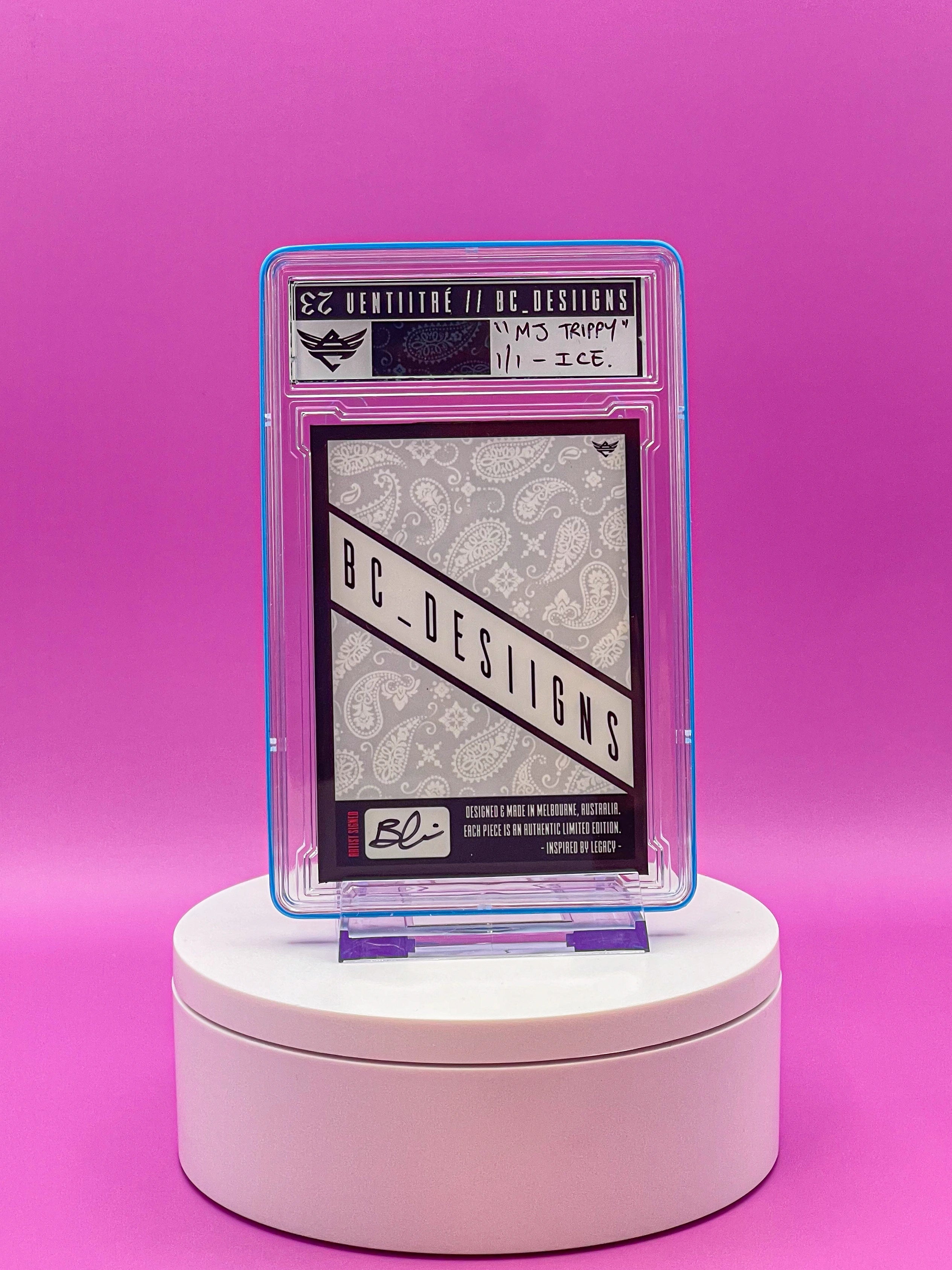 Card with 'BC Designs' branding in a protective case on a pink background