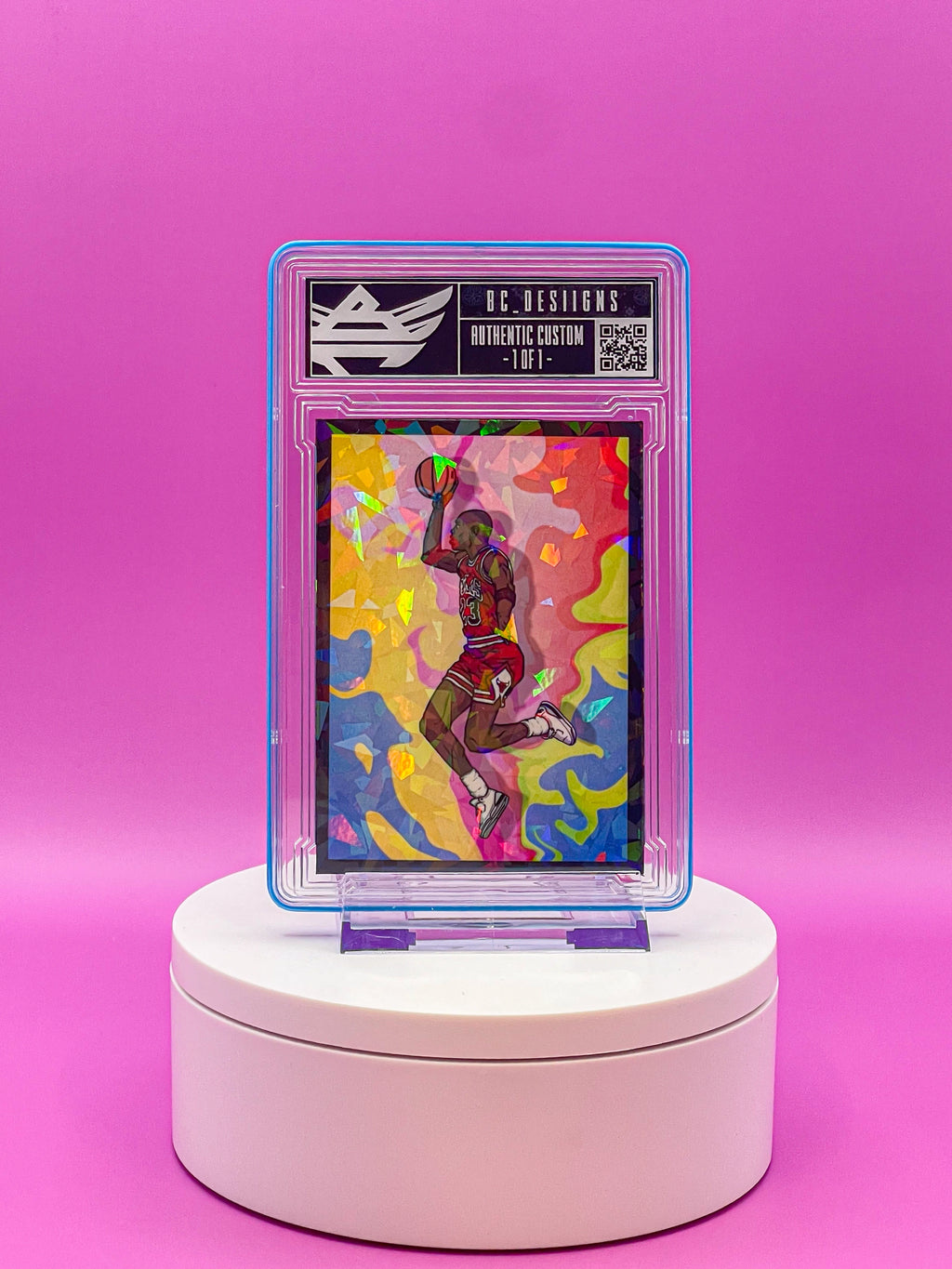 Collectible card on a white stand against a pink background