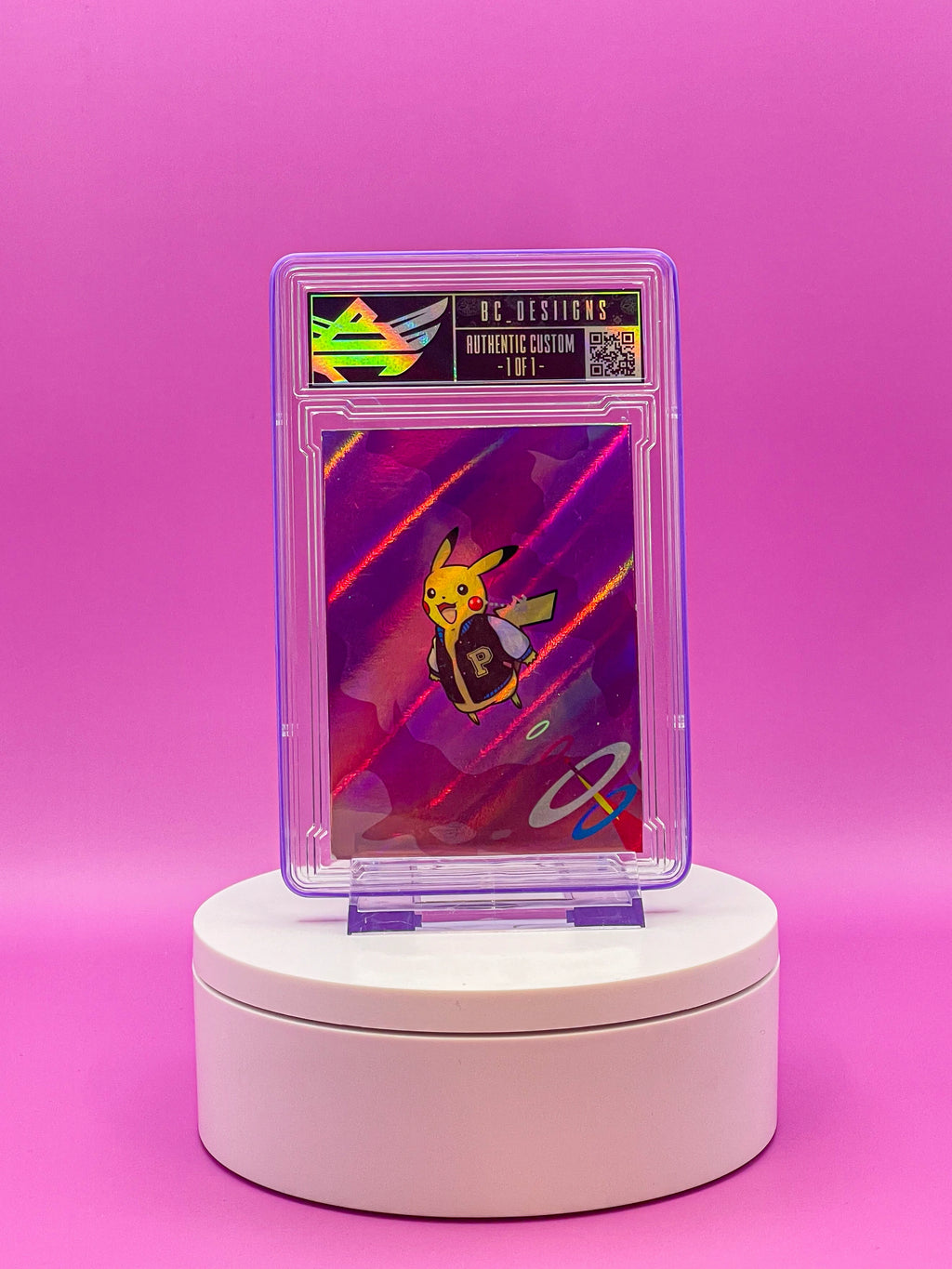 Card in a transparent holder on a white stand against a pink background