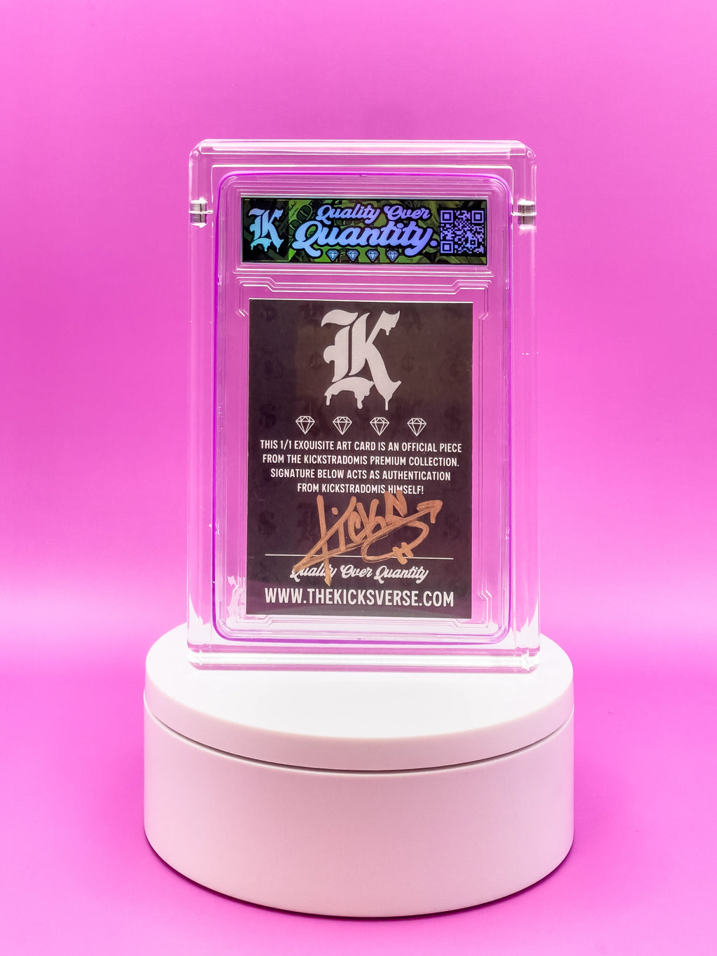 Card in a clear holder on a white stand against a pink background