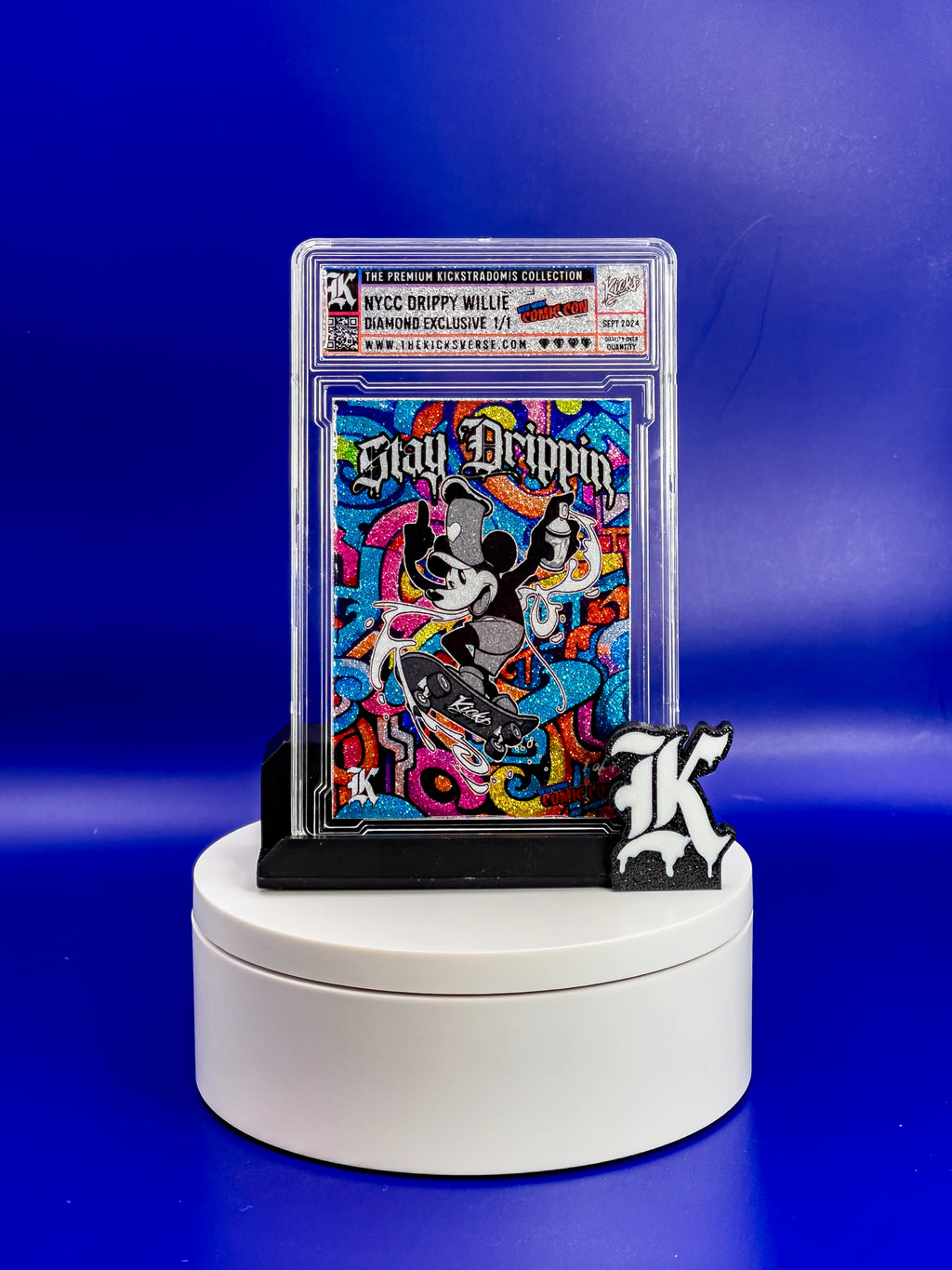 Collectible card in a protective case on a white platform with a blue background